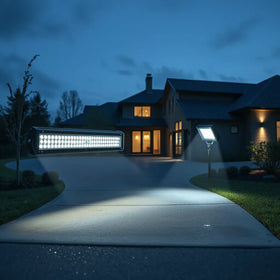 Weatherproof LED light bar and floodlights illuminating a driveway at dusk